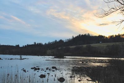 Scenic view of lake against sky during sunset