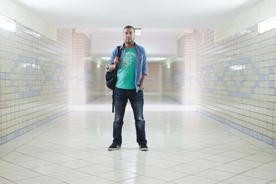 Full length view of man standing in corridor