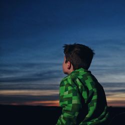 Boy looking at sky during sunset