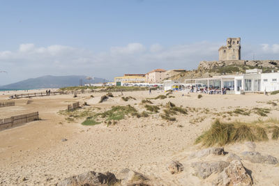 Houses on beach against sky