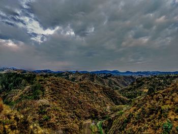 Scenic view of mountains against cloudy sky