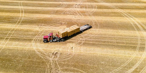 The loading of freshly cut bales on a rural farm in wisconsin