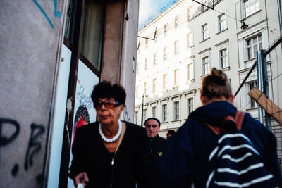 People standing by window in city