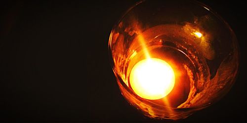 Close-up of light bulb at night