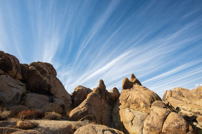 Low angle view of rocks against sky