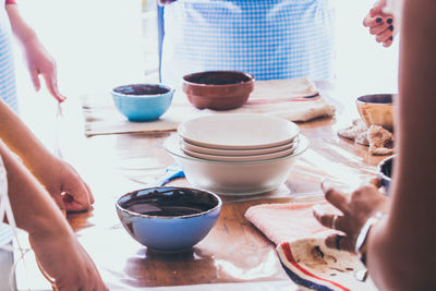 Midsection people preparing food on table