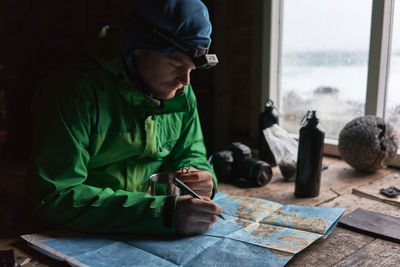 Man with map at table