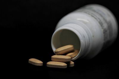 Close-up of electric lamp over black background