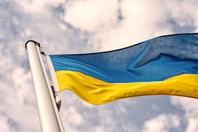 Low angle view of flag against sky