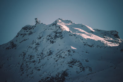 Scenic view of snowcapped mountains against clear sky