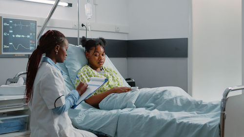 Doctor examining patient in hospital