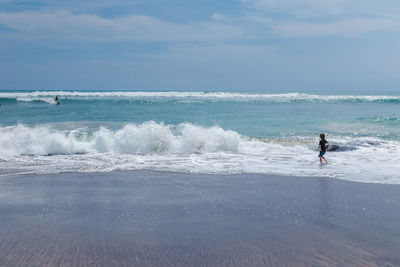 Full length of girl walking on shore at beach