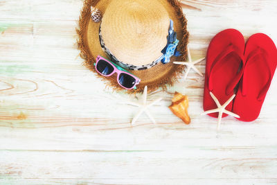 High angle view of sunglasses and shoes on wood