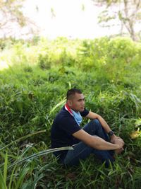 Thoughtful man sitting on land