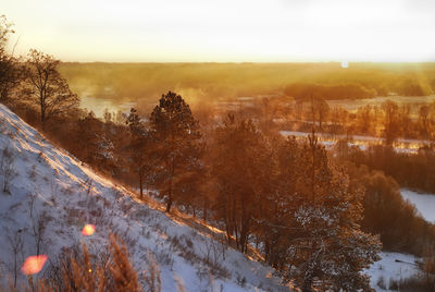 Scenic view of landscape against sky during winter