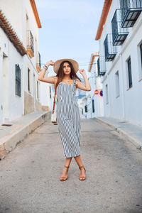 Full length of woman standing on street in city