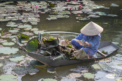 High angle view of woman sitting in rowboat