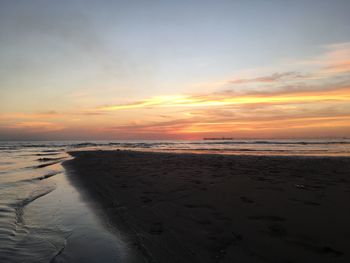 Scenic view of beach against sky during sunset