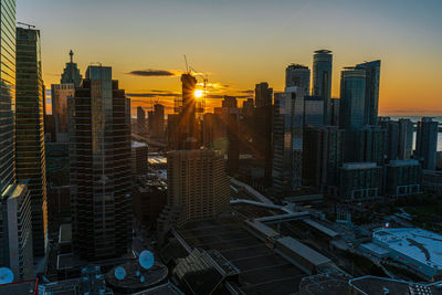 Aerial view of buildings in city during sunset