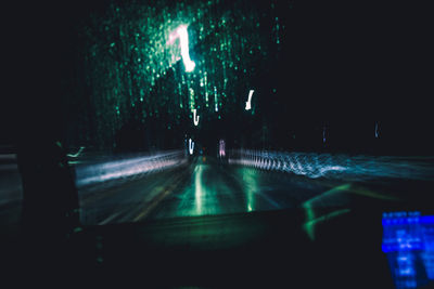 Illuminated light trails on street in city at night