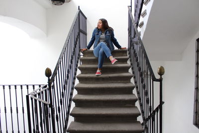 Low angle view of woman walking up stairs