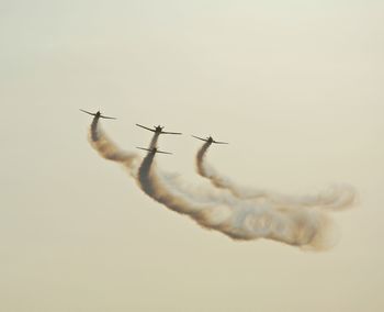 Low angle view of airplane flying against sky