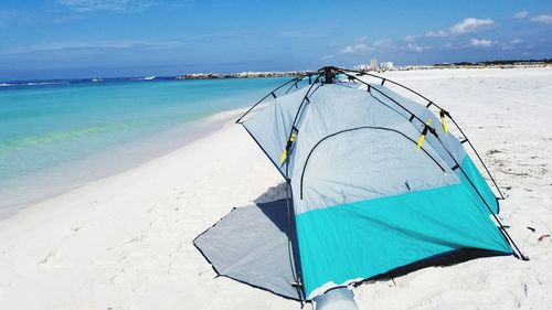 Scenic view of beach against blue sky