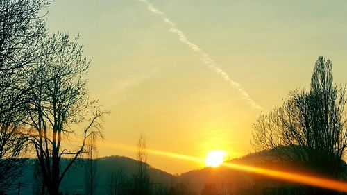 View of vapor trail in sky during sunset