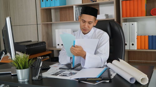 Portrait of young woman working in office