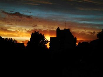 Silhouette trees against sky during sunset