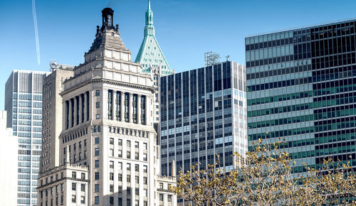 Low angle view of buildings against blue sky