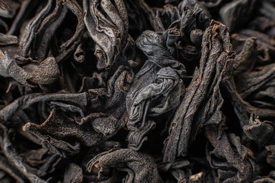Dry black tea leaves close up. macro background of tea production