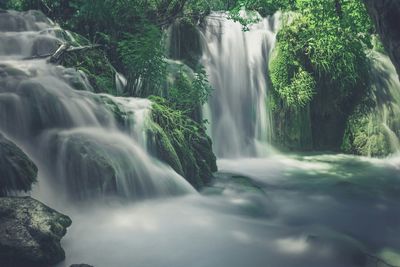 Scenic view of river flowing through rocks