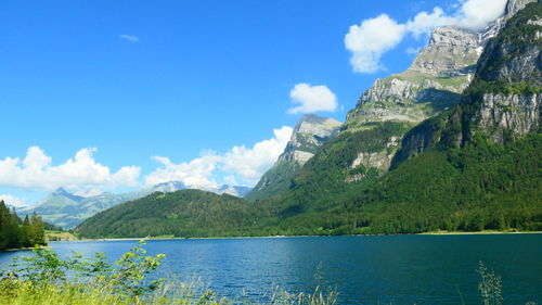 Scenic view of lake and mountains against sky