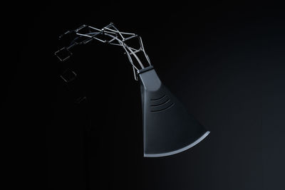 Close-up of electric lamp against black background