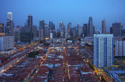 Aerial view of modern buildings in city against clear sky