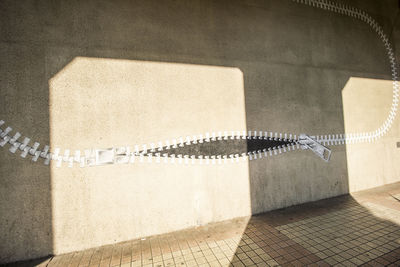 Shadow of railing on wall