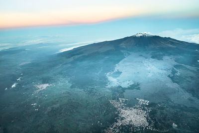 Aerial view of volcanic crater against sky during sunset