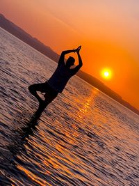 Low section of person at beach during sunset