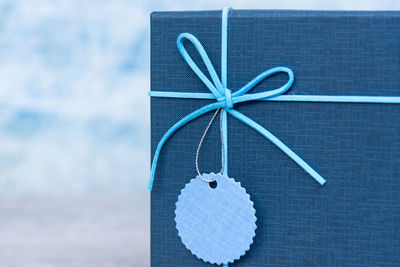 Close-up of decoration hanging against blue wall