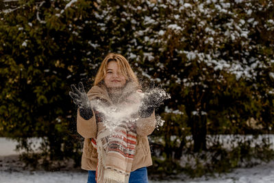 Rear view of woman standing on snow