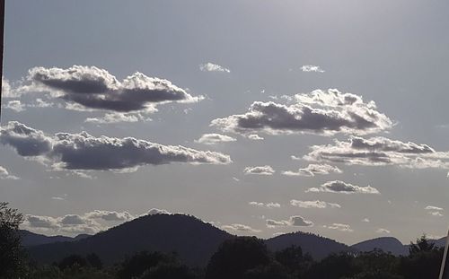 Low angle view of silhouette mountains against sky