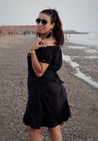 Beautiful woman standing on beach