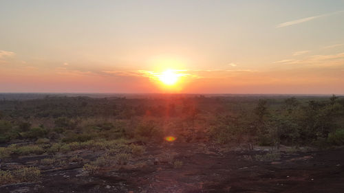 Scenic view of field against sky during sunset