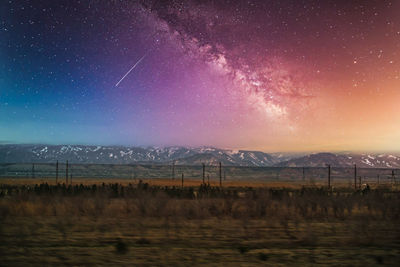 Scenic view of field against sky at night