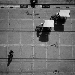 High angle view of man and cyclist on urban street