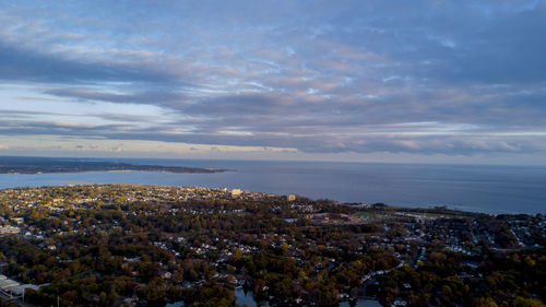 Scenic view of sea and cityscape against sky