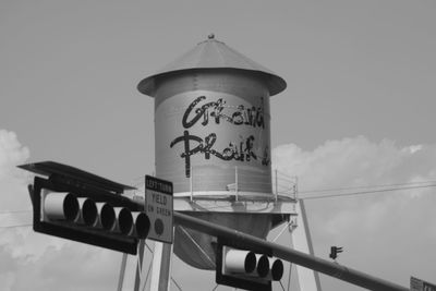 Low angle view of information sign against sky