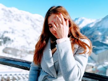 Beautiful woman standing in snow