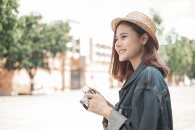 Portrait of smiling young woman using mobile phone